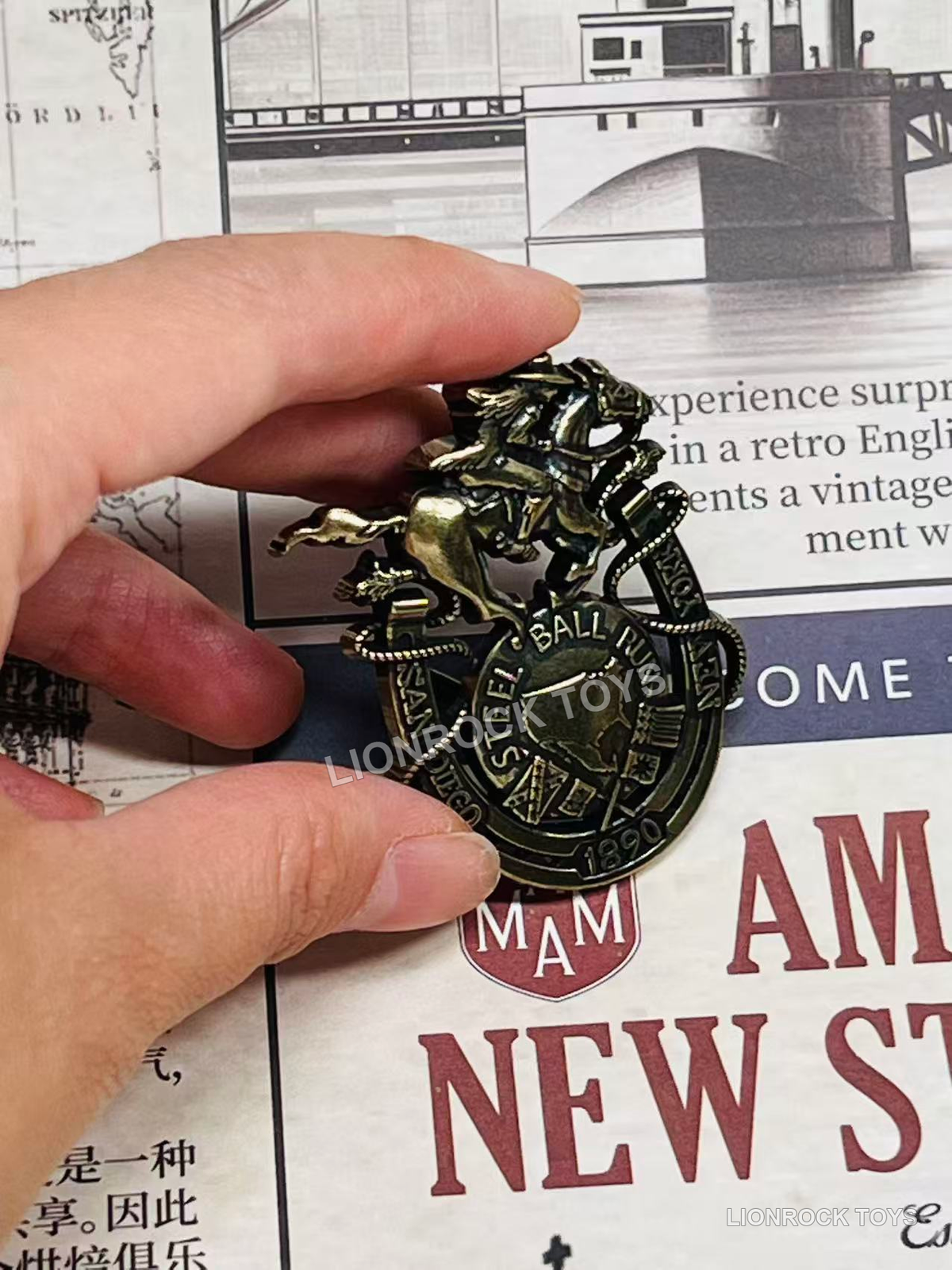 Horse and rider decorative badge held in hand for a closer view.