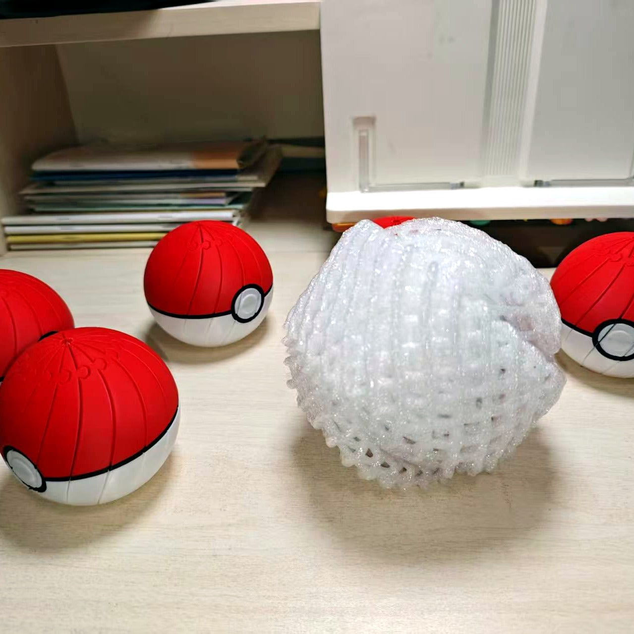 Small batch of 3D printed Poke Ball spiral fidget toys