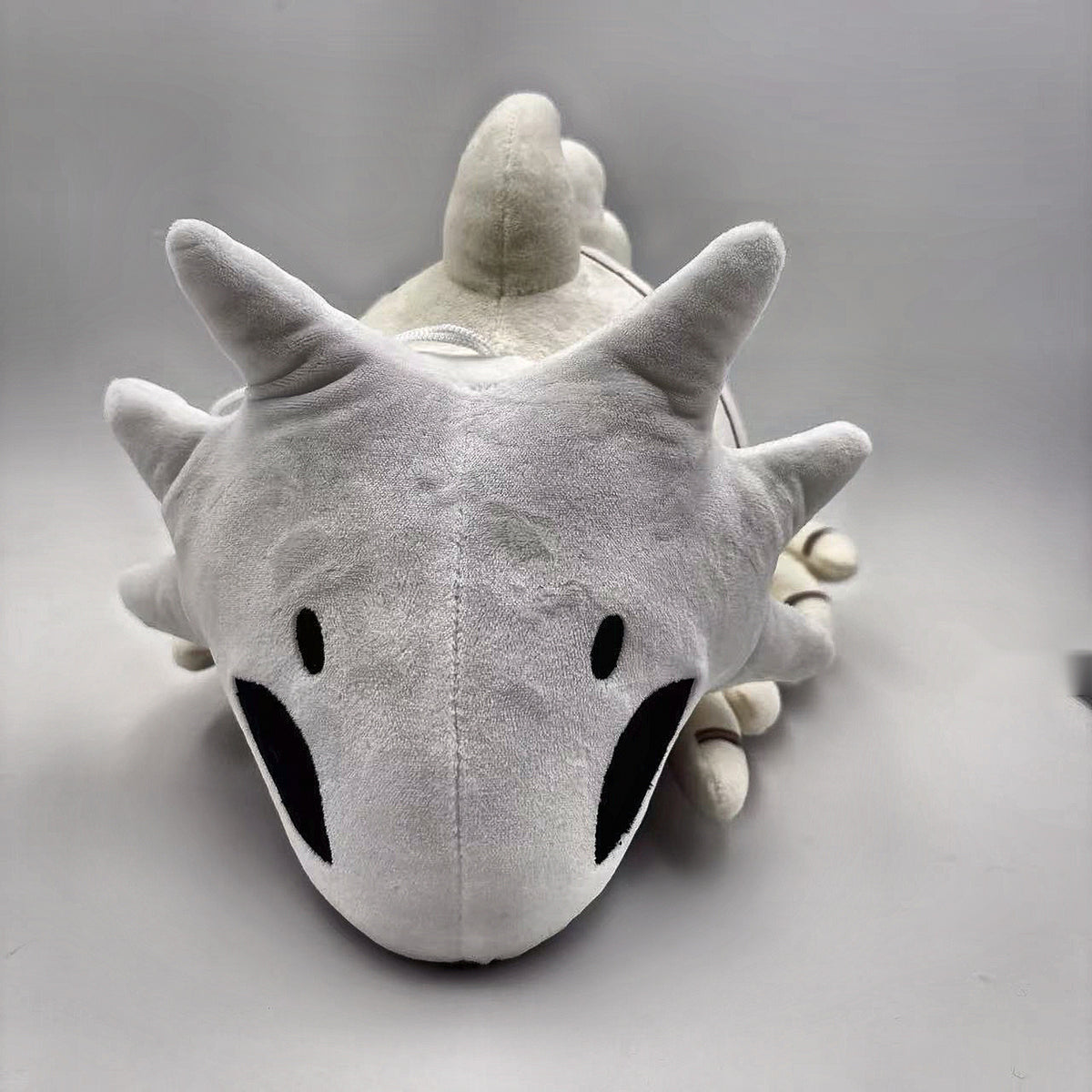 Bell Beast plush front view showing face and crown spikes