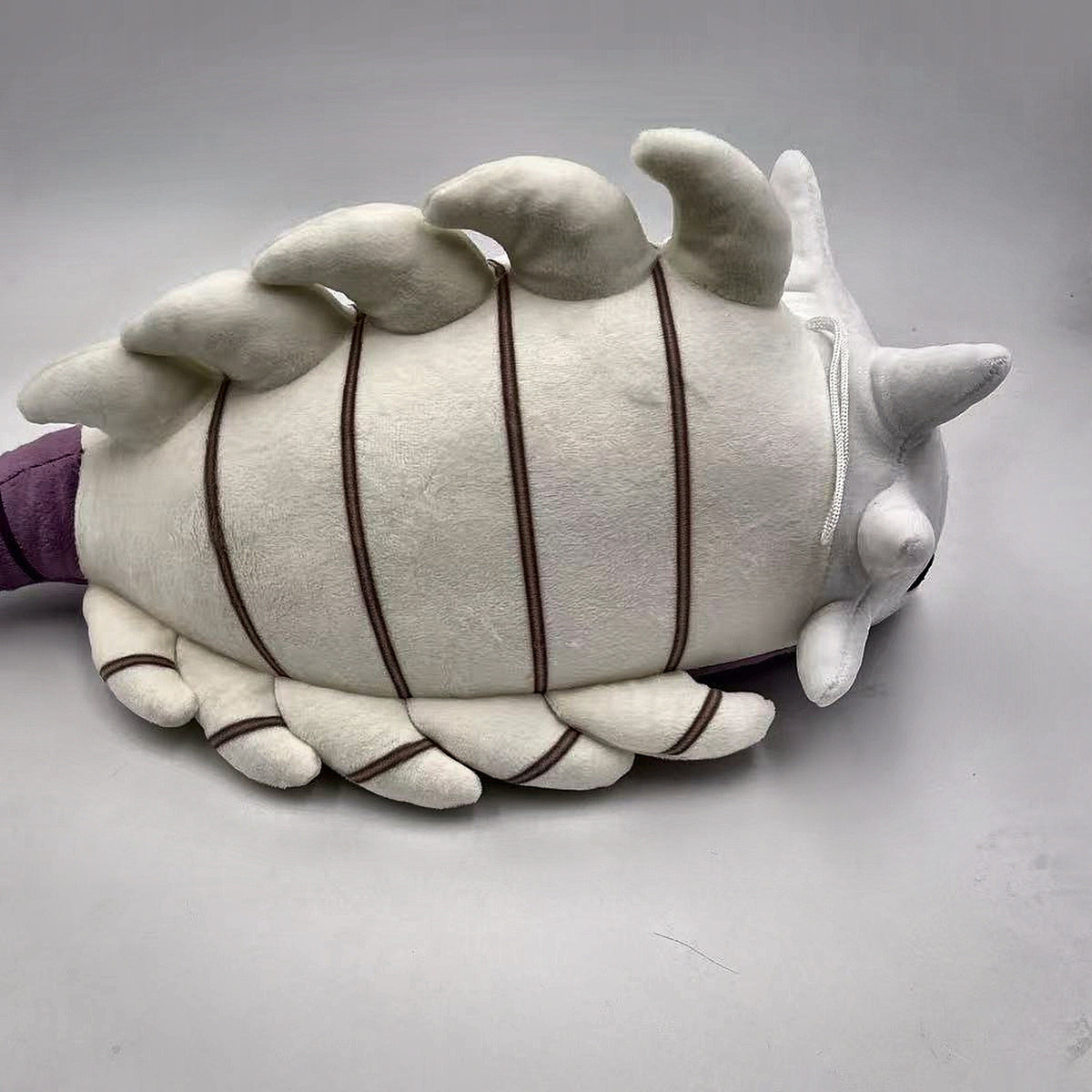 Bell Beast plush three-quarter view showing back spikes