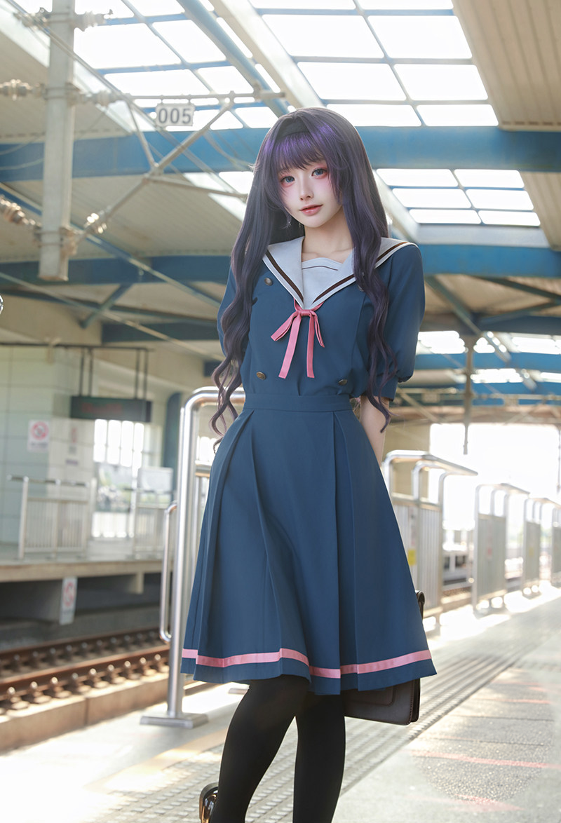 Blue sailor uniform with white collar and pink ribbon — front view
