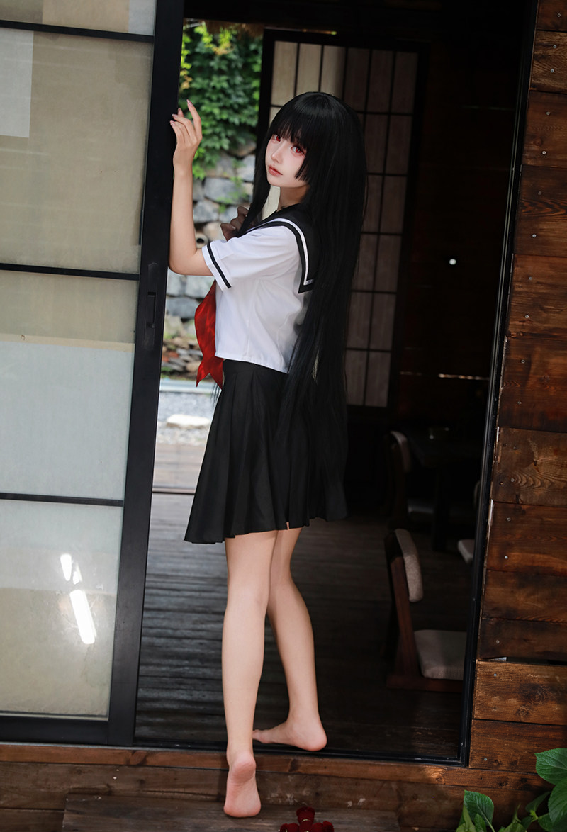 White sailor top with black skirt and red neck scarf — standing front-side view