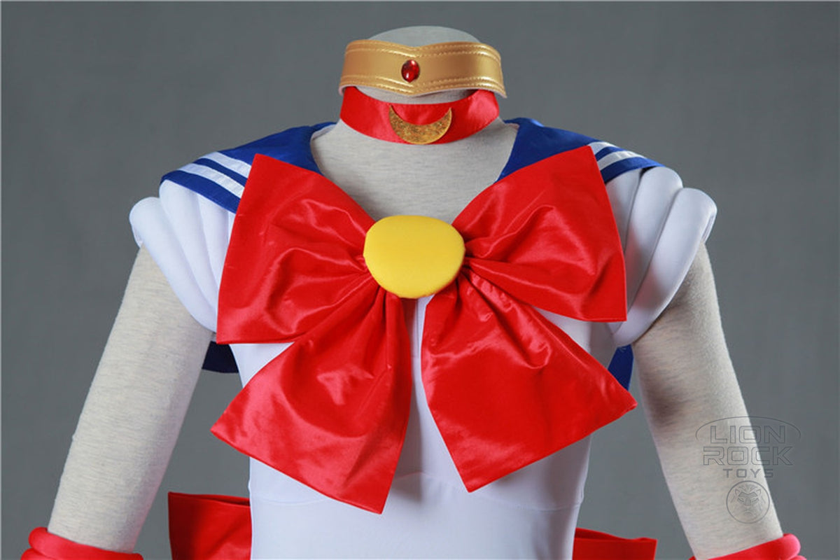 Red chest bow with gold brooch, gold headband and choker - close up