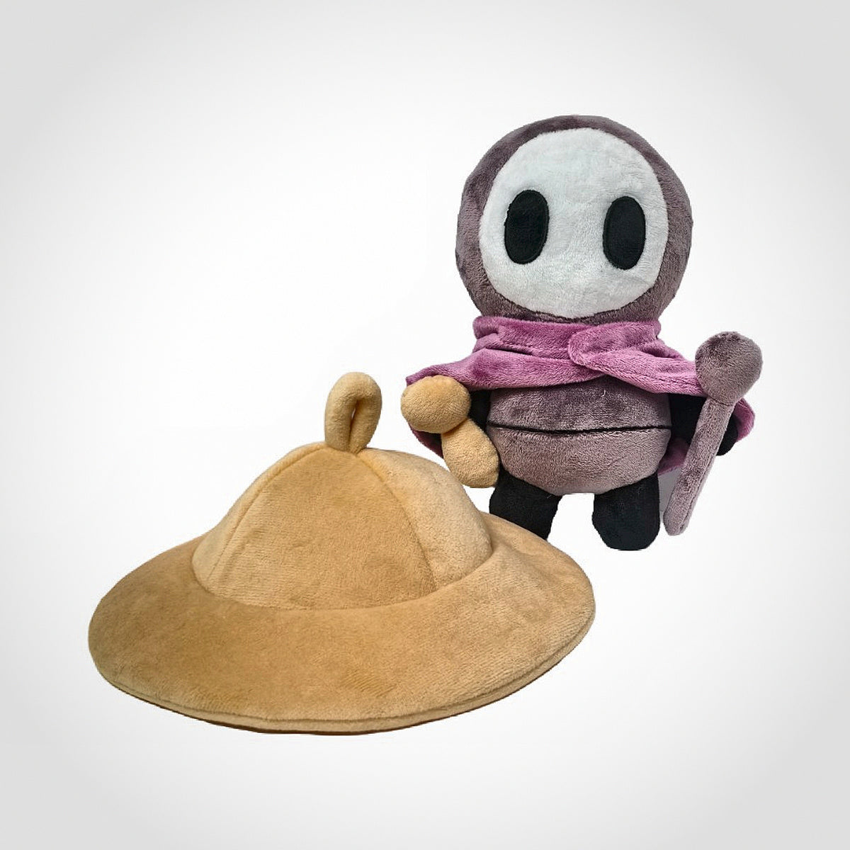 Sherma plush seated with hat placed beside it