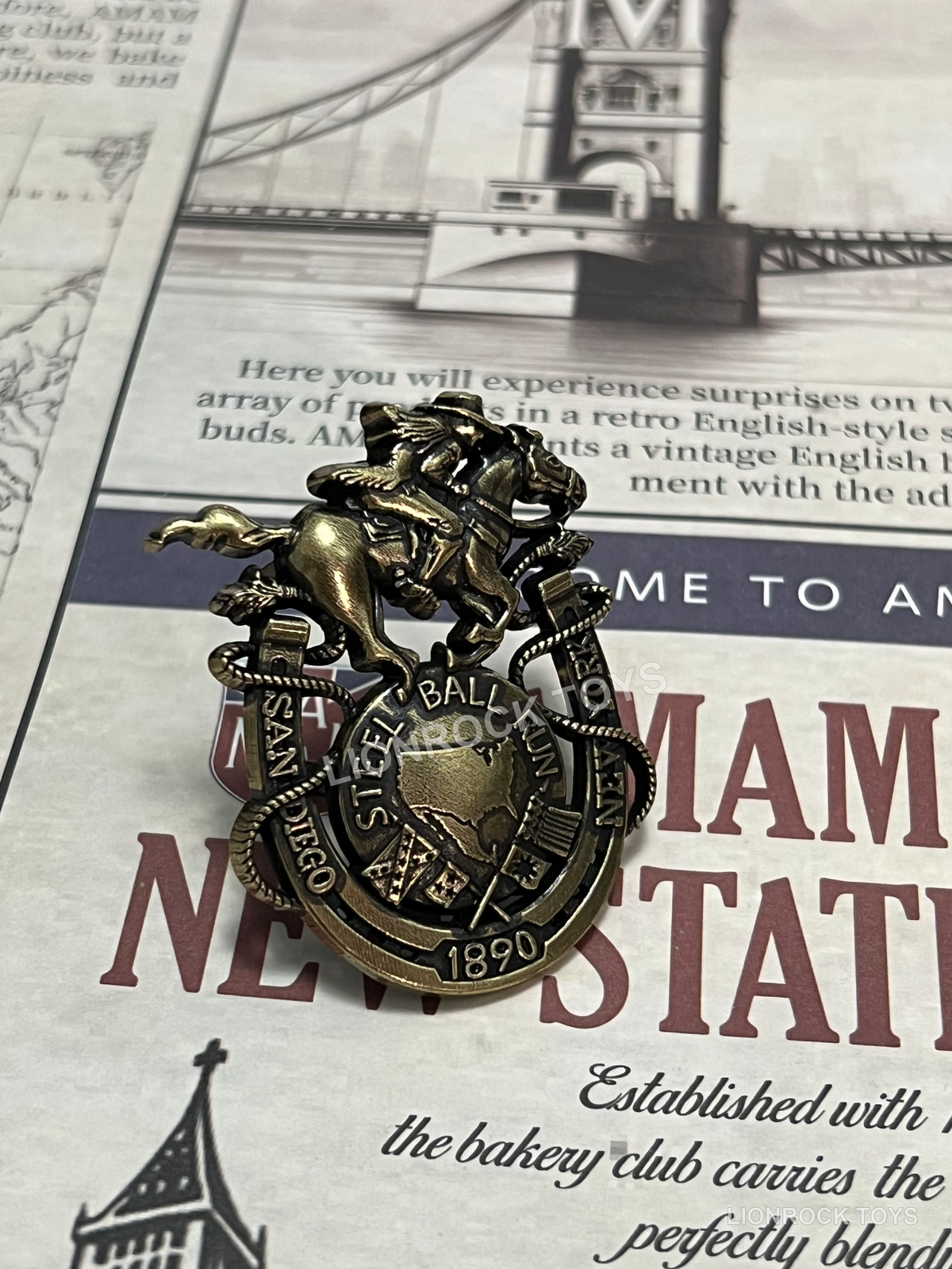 Antique gold-tone horse and rider decorative badge, front view.